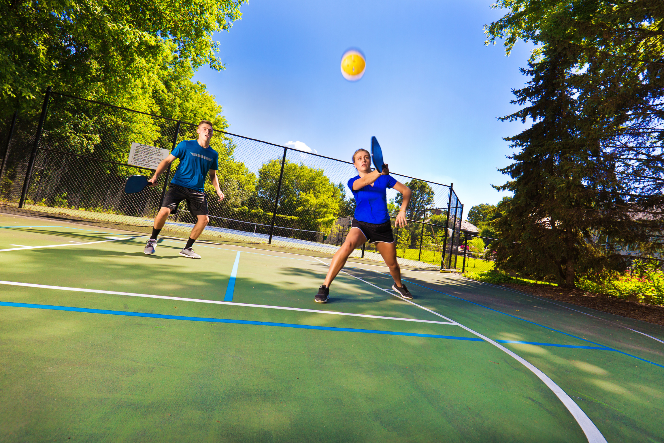 Two Young Teenagers Playing Pickle Ball